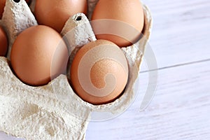 Eggs in a cardboard box. Open egg packaging, close-up