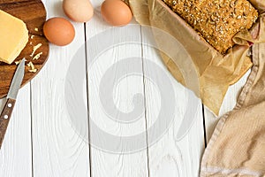 Eggs, Cheese and Homemade Gluten free Sweet Bread in the Baking Dish on a Light White Wooden Background. Rural Kitchen or Bakery -