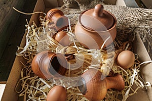 Eggs , clay jurs of different sizes, on burlap, mansion.