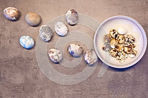 eggs on concrete. Happy Easter card: marble stone effect painted. top view, quail eggs flat lay