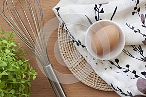 Eggs cooking for breakfast, a protein form yolk and albumen on a white background, or on a plain wooden table.