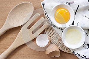 Eggs cooking for breakfast, a protein form yolk and albumen on a white background, or on a plain wooden table.