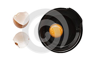 Eggs cooking for breakfast, a protein form yolk and albumen on a white background, or on a plain wooden table.