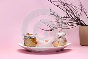 Eggs decorated with ribbons on a plate. Easter background