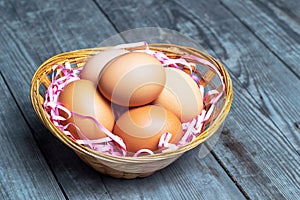 Eggs on decorative straw in a basket