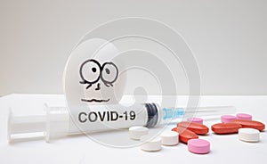 Eggs drawn frightened faces alcohol syringe covid-19 and coronavirus, photo