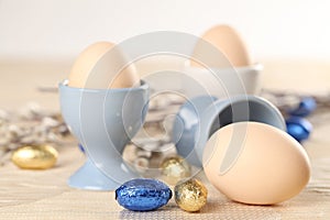 Eggs in eggcups and chocolate easter eggs