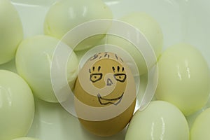 Eggs Faces, drawnigs on eggs. An egg staring with dramatic face expression at an empty eggschell .
