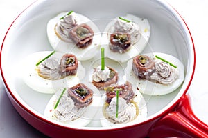 eggs filled with anchoa spread with anchoa on the top photo