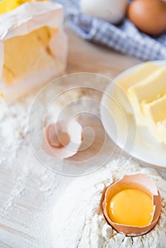 Eggs, flour, butter, pasta or baking ingredients on a wooden table . Selective focus