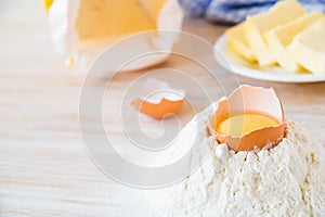 Eggs, flour, butter, pasta or baking ingredients on a wooden table . Selective focus