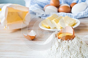 Eggs, flour, butter, pasta or baking ingredients on a wooden table . Selective focus