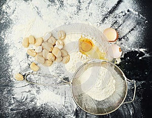 Eggs, flour and pasta for cooking in kitchen with Italian cuisine, dough recipe and dinner ingredients. Gnocchi, table