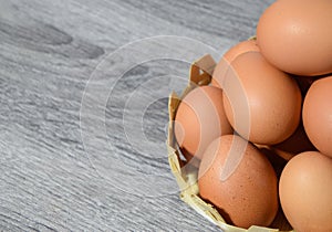 Eggs on  gray table background - Many eggs in a small bamboo basket on the gray wooden floor, Chicken eggs contain protein and