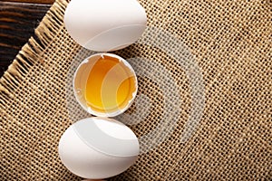 Eggs and Half broken egg with yolk flatlay