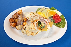 Eggs ham cheese and spinach breakfast wrap platter