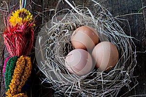 Eggs in a nest with a sack on an old wooden table
