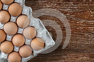 Eggs in the package on a wooden background