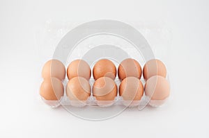 Eggs in plastic box on white background.