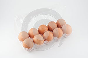 Eggs in plastic box on white background.