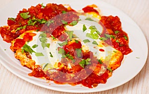 Eggs poached in a sauce of tomatoes, chili peppers, and onions