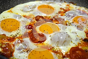 `Eggs in Purgatory`, a traditional Mediterranean dish of Italian cuisine for breakfast with poached eggs on a spicy tomato sauce