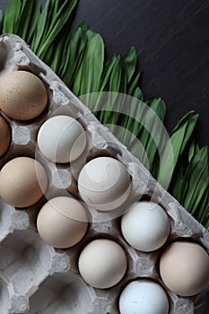 Eggs and Ramson on a black table, wood garlic