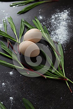 Eggs and Ramson on a black table, wood garlic and flour