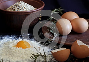 Eggs, rosemary, flour and oatmeal. Ingredients for cooking homemade, delicious breakfast food