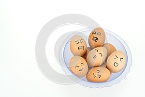 Eggs with smiling happy faces on plastic bowl, isolated on white background