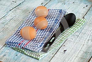 Eggs with spoon and dish towel
