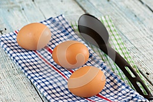 Eggs with spoon and dish towel