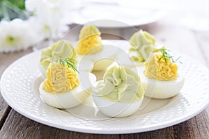 Eggs stuffed with cheese and avocado mousse on Easter table