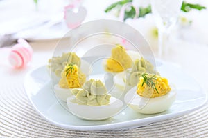 Eggs stuffed with cheese and avocado mousse on Easter table
