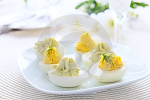 Eggs stuffed with cheese and avocado mousse on festive table