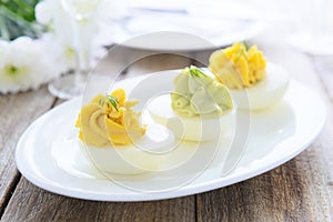 Eggs stuffed with cheese and avocado mousse