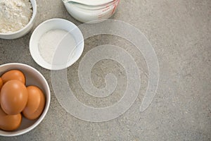 Eggs with sugar and flour in bowls