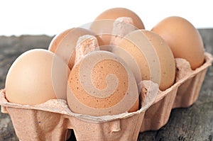 Eggs in a tray on a wooden table.