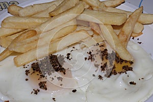 Eggs with truffles above and chips