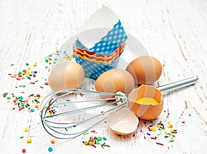 Eggs, whisk and cupcake liners