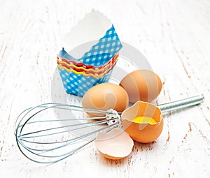 Eggs, whisk and cupcake liners