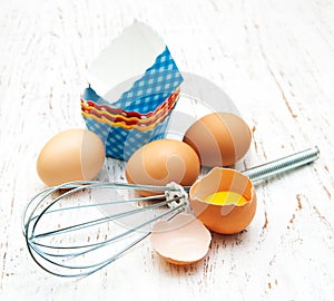 Eggs, whisk and cupcake liners