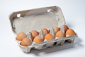 Eggs on a white background. Chicken eggs in a paper box