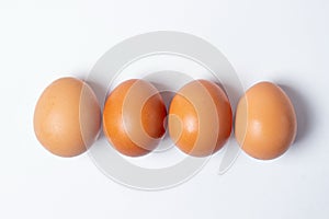 Eggs on a white background. Chicken eggs are in a row