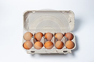 Eggs on a white background. Chicken eggs in a paper box