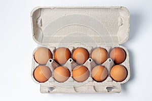 Eggs on a white background. Chicken eggs in a paper box