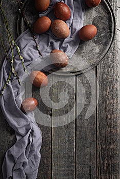 Eggs on a wooden background as a symbol of Easter. Country style.