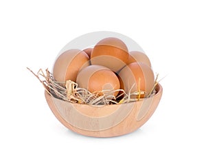 Eggs in wooden bowl isolated on white background