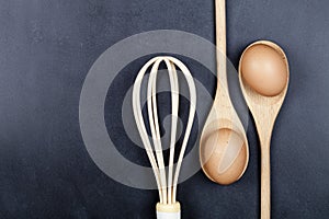 Eggs, wooden spoon and whisker