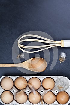 Eggs, wooden spoon, whisker and feathers